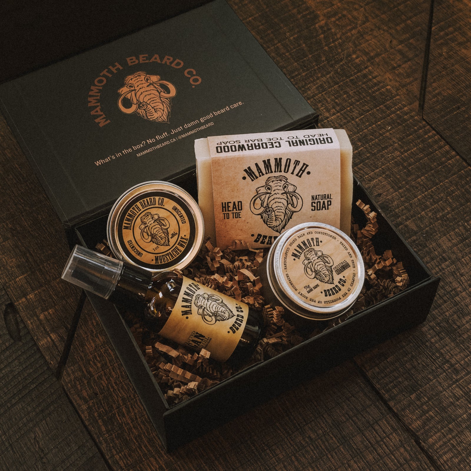 Mammoth Beard Co. grooming products in a box on a wooden surface