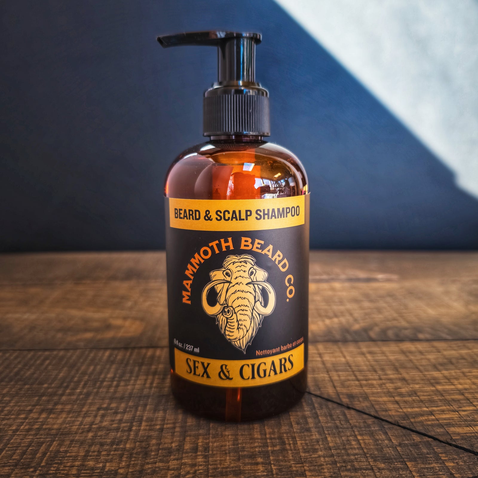 Sex and Cigars Shampoo Gel on a wooden platform against a dark background.
