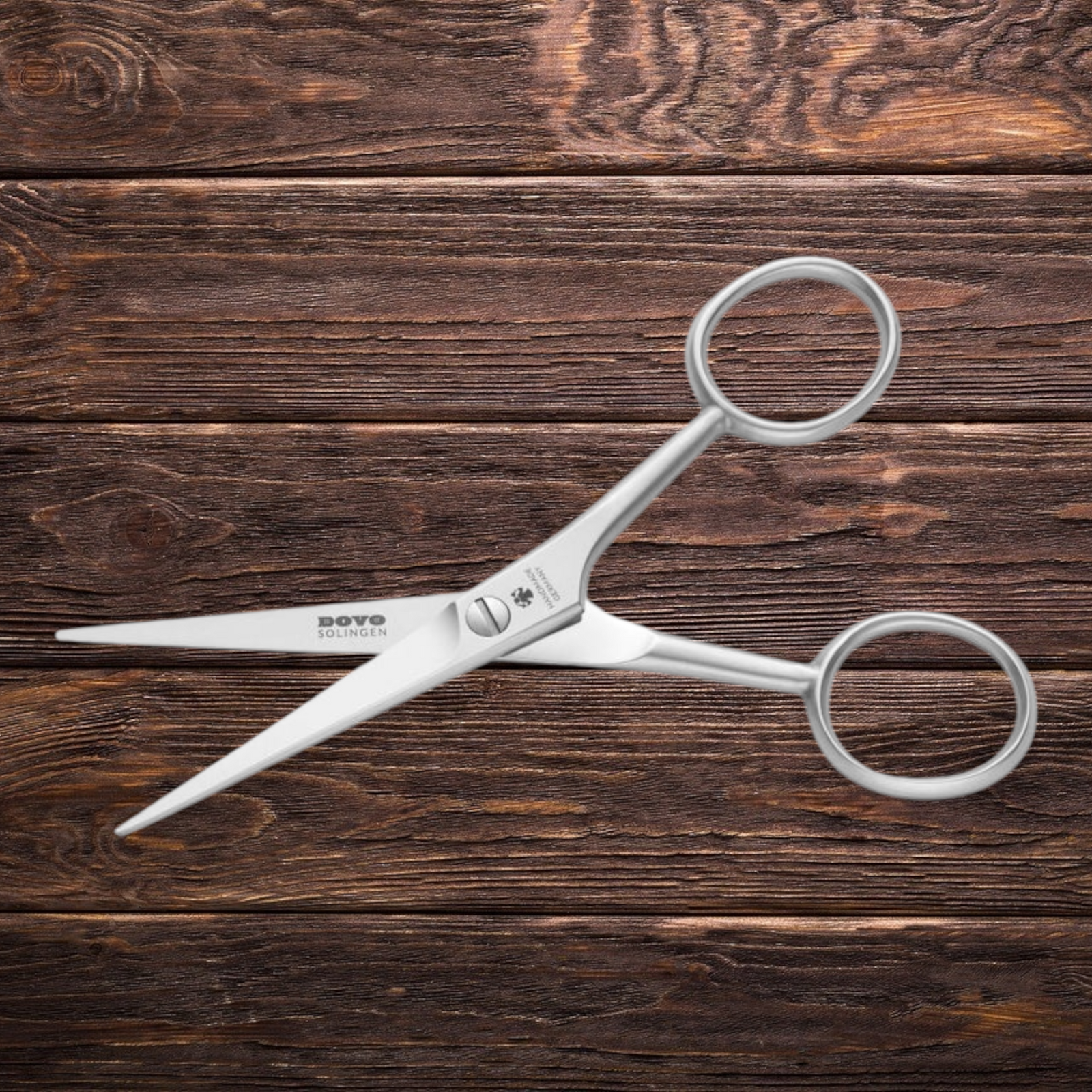 DOVO Solingen beard and moustache scissors with precision stainless steel blades displayed on a rustic wooden surface