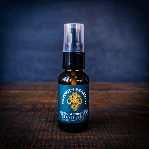 Mammoth Beard Co Cedar & Mint Hazelnut & Hemp Beard Oil bottle on rustic wooden table, lightweight daily beard oil for beard, skin and hair.