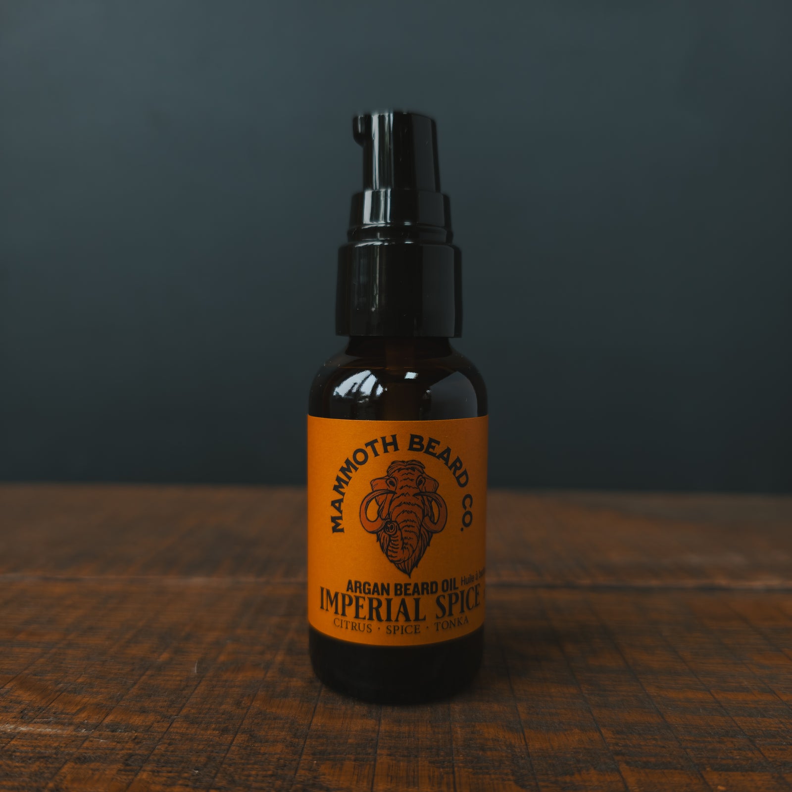 A bottle of Imperial Spice Beard Oil on a dark background