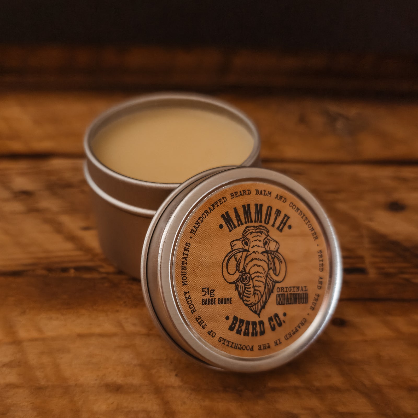 Mammoth Beard Co. beard balm container on a wooden surface