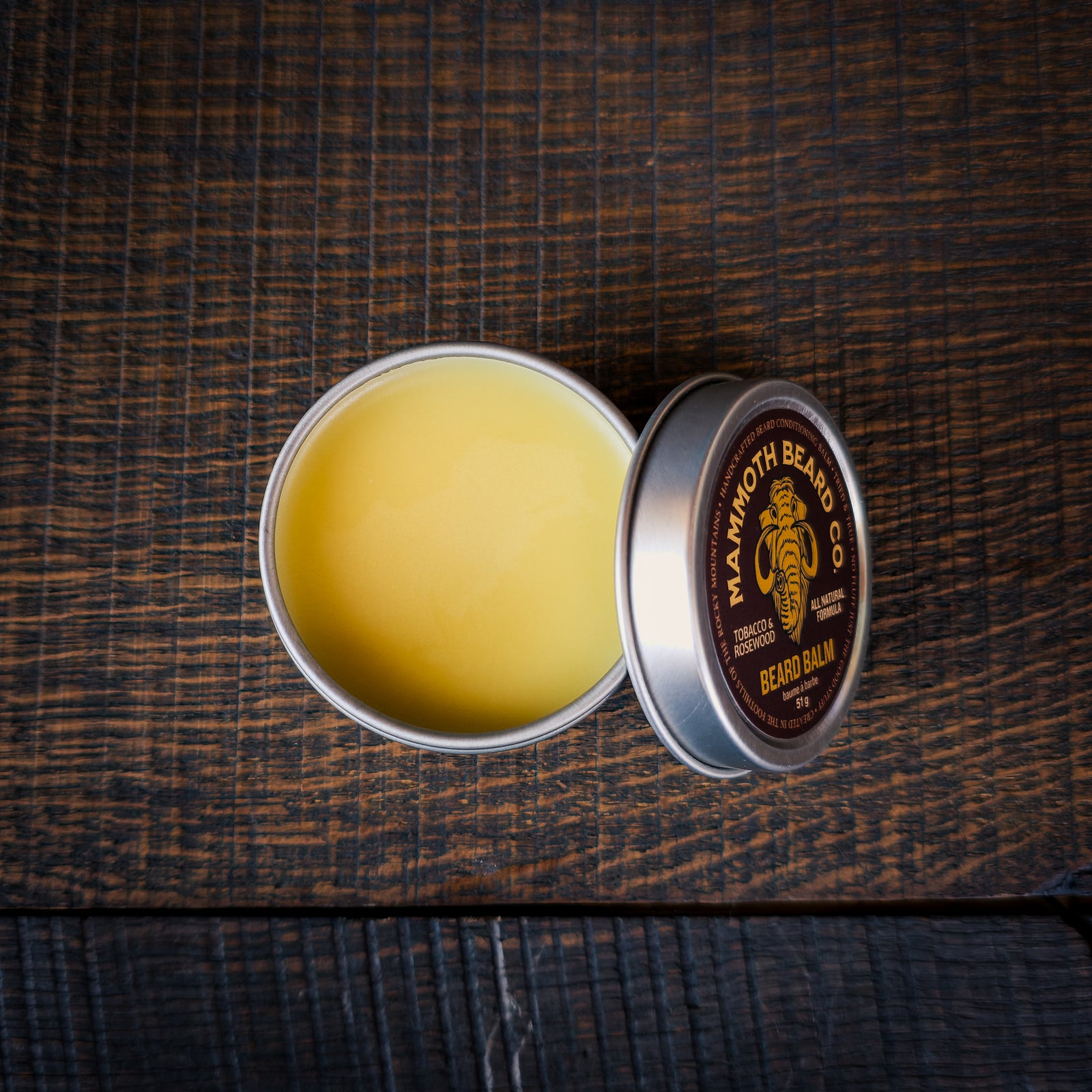 Open tin of Mammoth Beard Co Tobacco & Rosewood beard balm showing smooth natural balm texture for conditioning and beard control