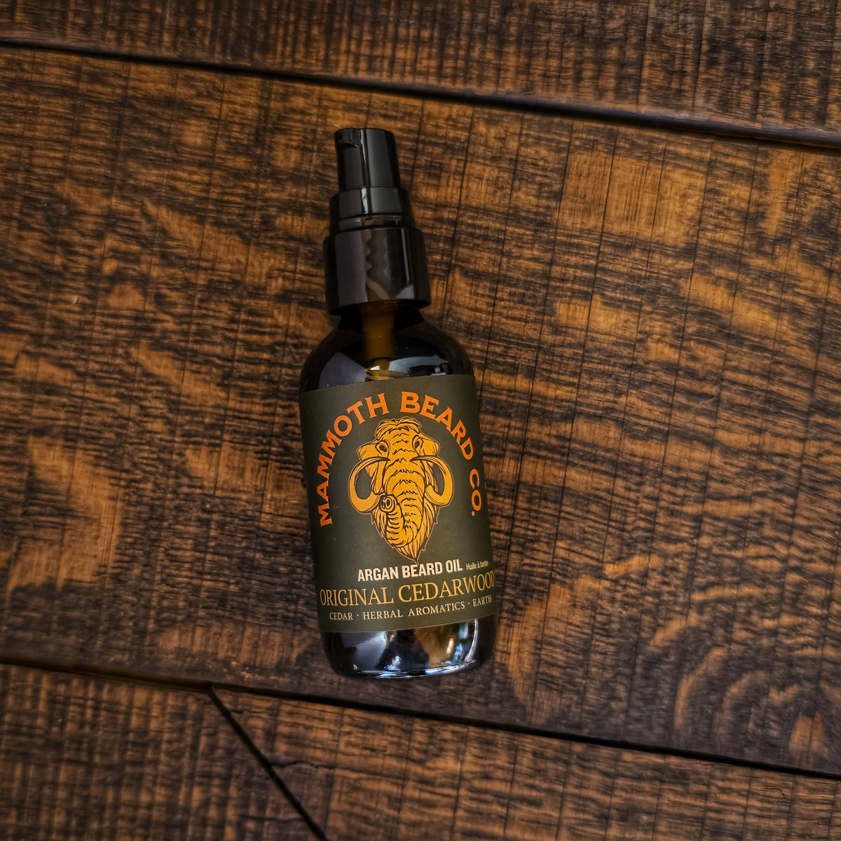 Mammoth Beard Co. Original Cedarwood beard oil bottle on a wooden surface