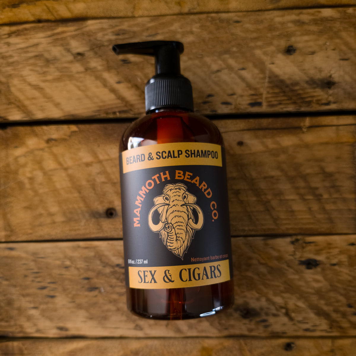 Bottle of Mammoth Beard Co. beard and scalp shampoo on a wooden background