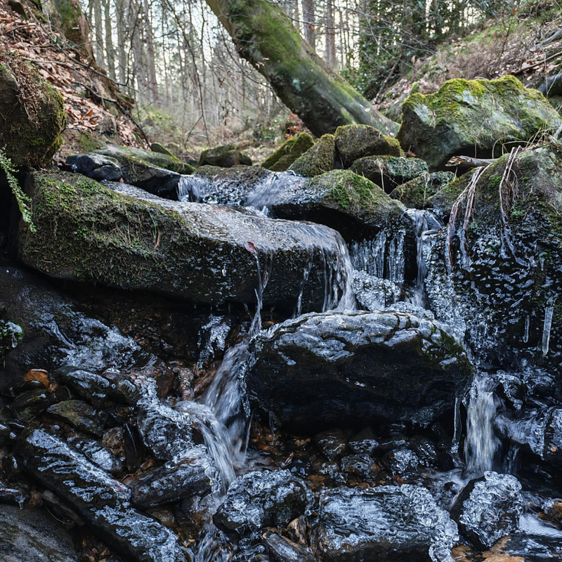 Rock under a stream representing acne under the beard